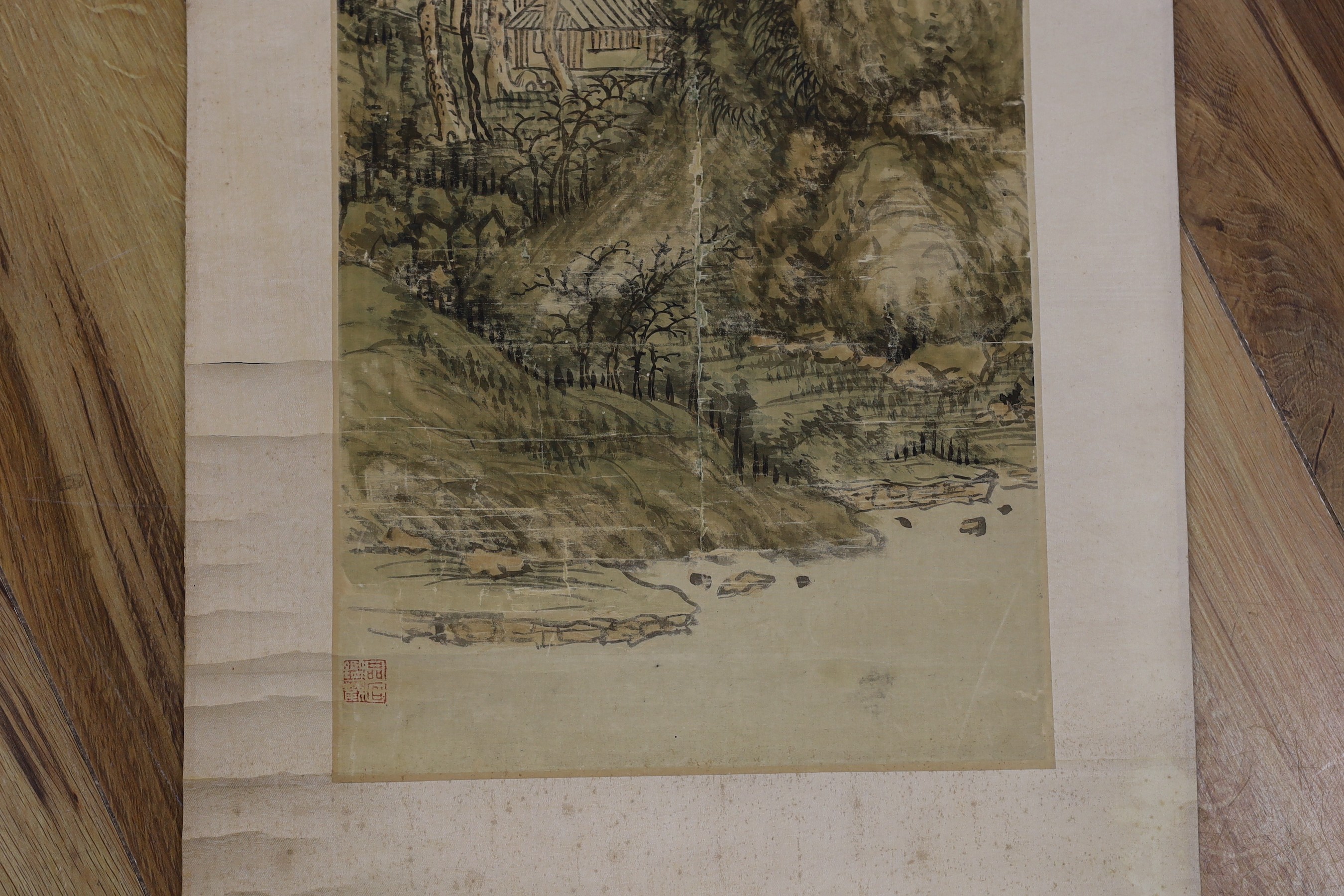 A Chinese landscape scroll painting on silk, Qing dynasty inscribed and signed, artist’s seal and collector’s seal lower left, image 139cm x 27.5cm, remounted